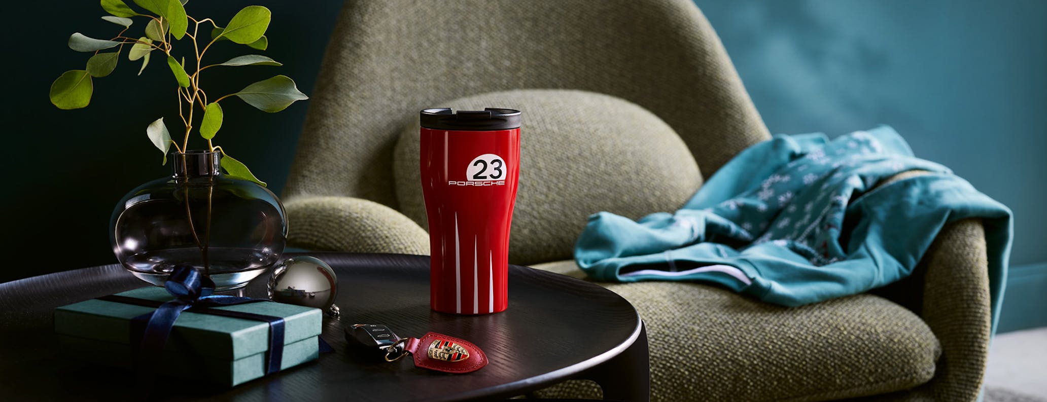 Coffee mug and Porsche key ring on living room table 