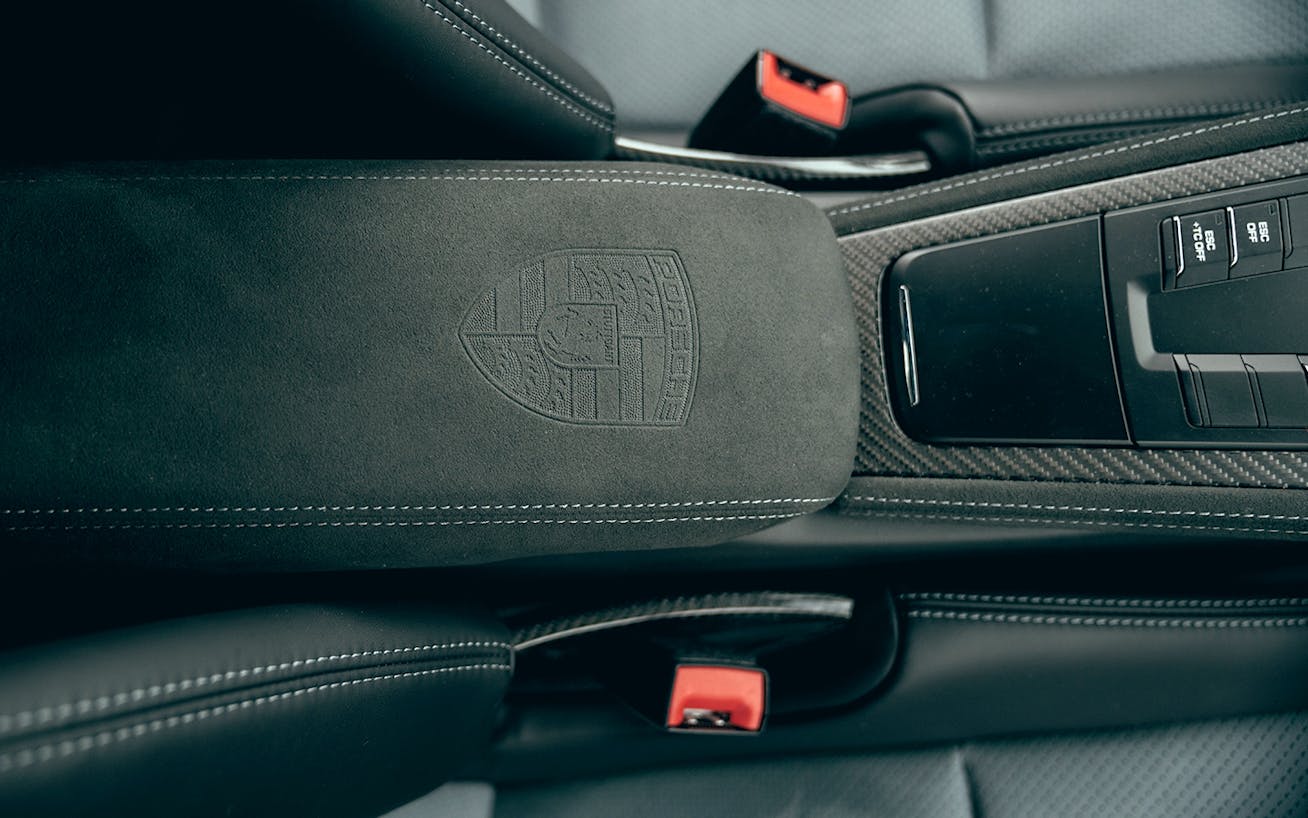 Overhead view of centre console with Porsche crest embossing