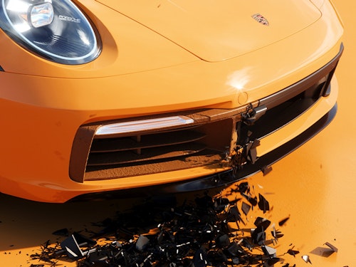 Orange Porsche, black grill peeling off onto floor