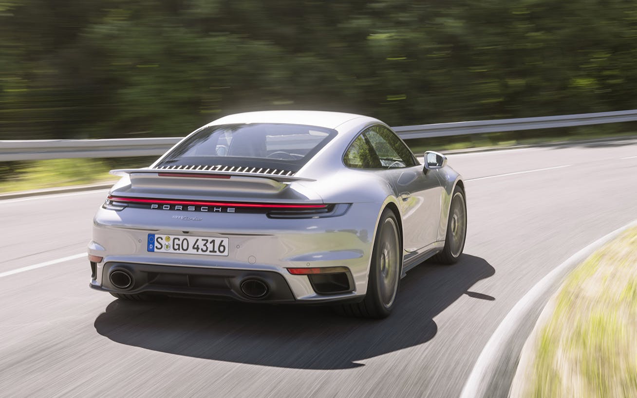 Porsche 911 Turbo (type 992) in GT Silver Metallic cornering on public road