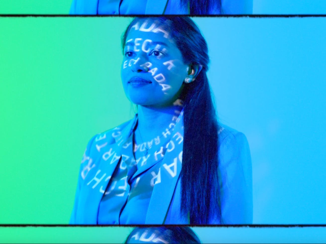 Close-up of woman in front of screen showing car lights