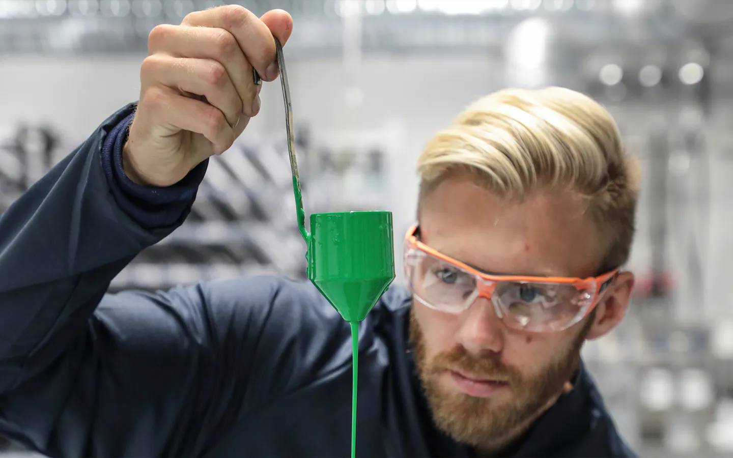 Man holding up a container of green Porsche Paint To Sample paint