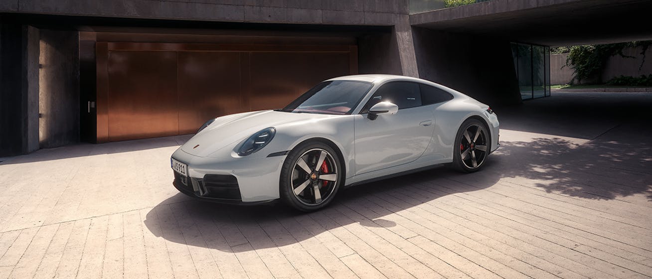 Sunlit Porsche 911 Carrera S parked in courtyard