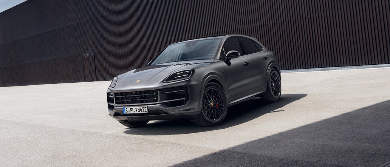 Camouflaged Porsche Cayenne Electric on racetrack 