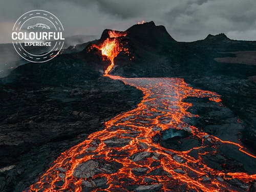 River of orange lava flows down from Mount Etna, Sicily