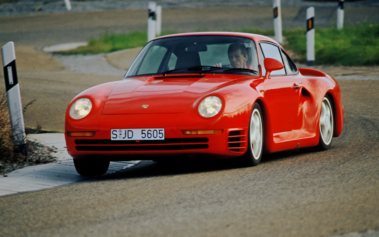 Porsche 959 driven by former World Rally Champion Walter Röhrl cornering on road