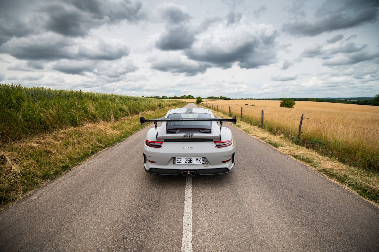 Porsche 911 GT3 RS from rear on an empty road