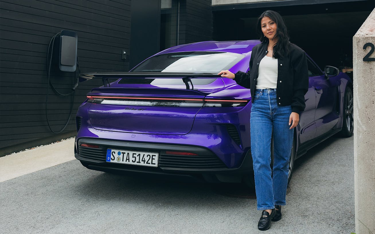 Woman leaning on purple Porsche Taycan Turbo GT 