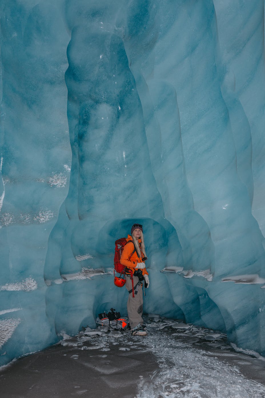 Woman standing inside the ice caves at Vatnajökull in Iceland