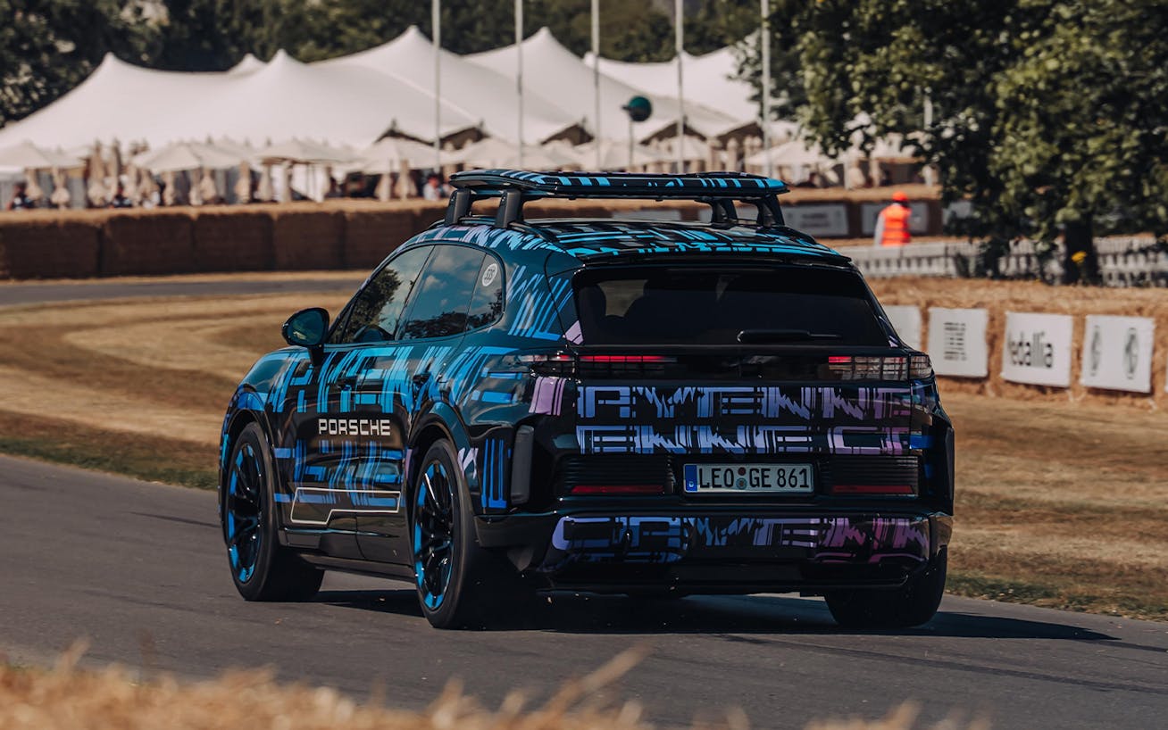 Camouflaged Porsche Cayenne Electric on racetrack 