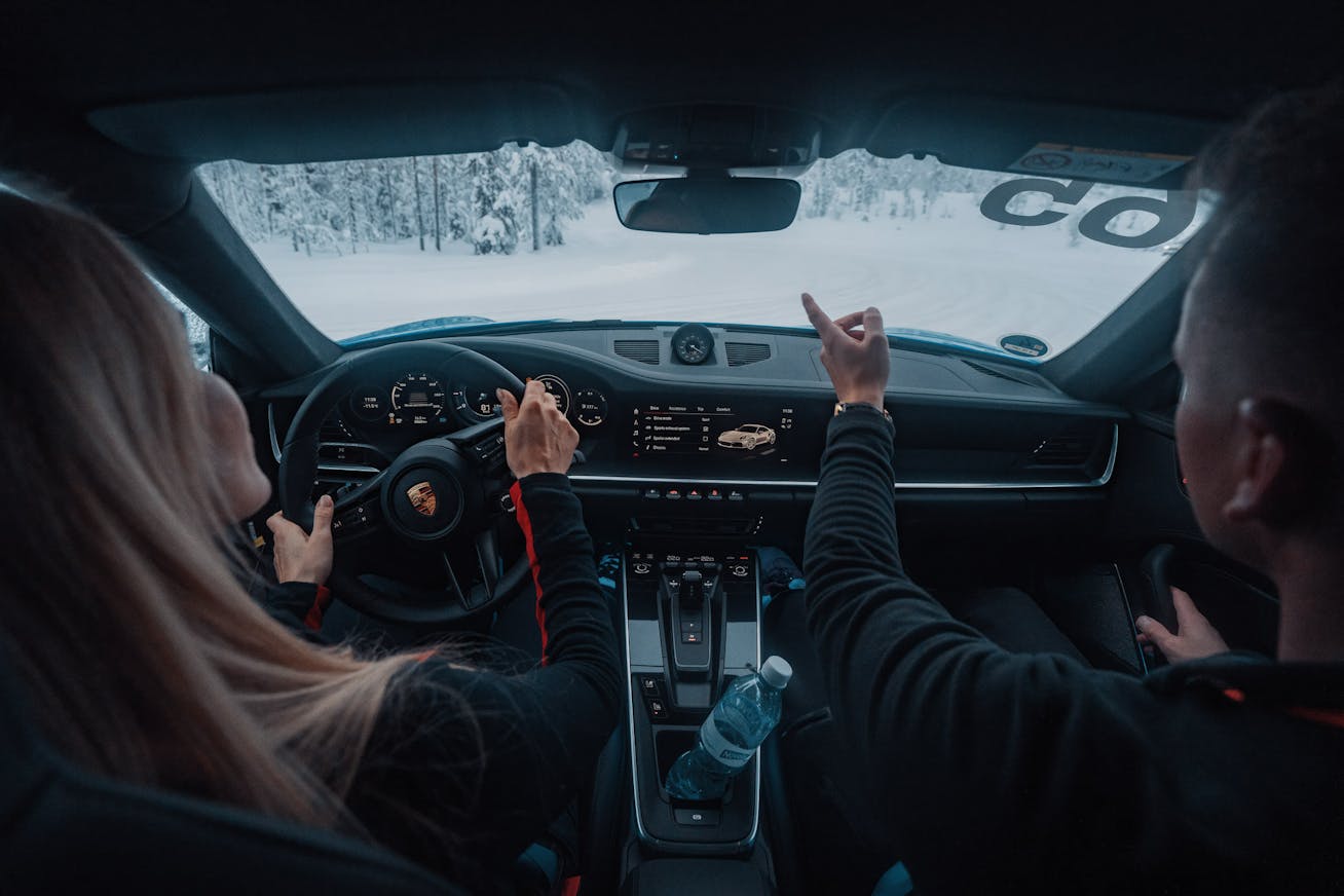 Man and woman in 911 on Porsche Ice Experience event