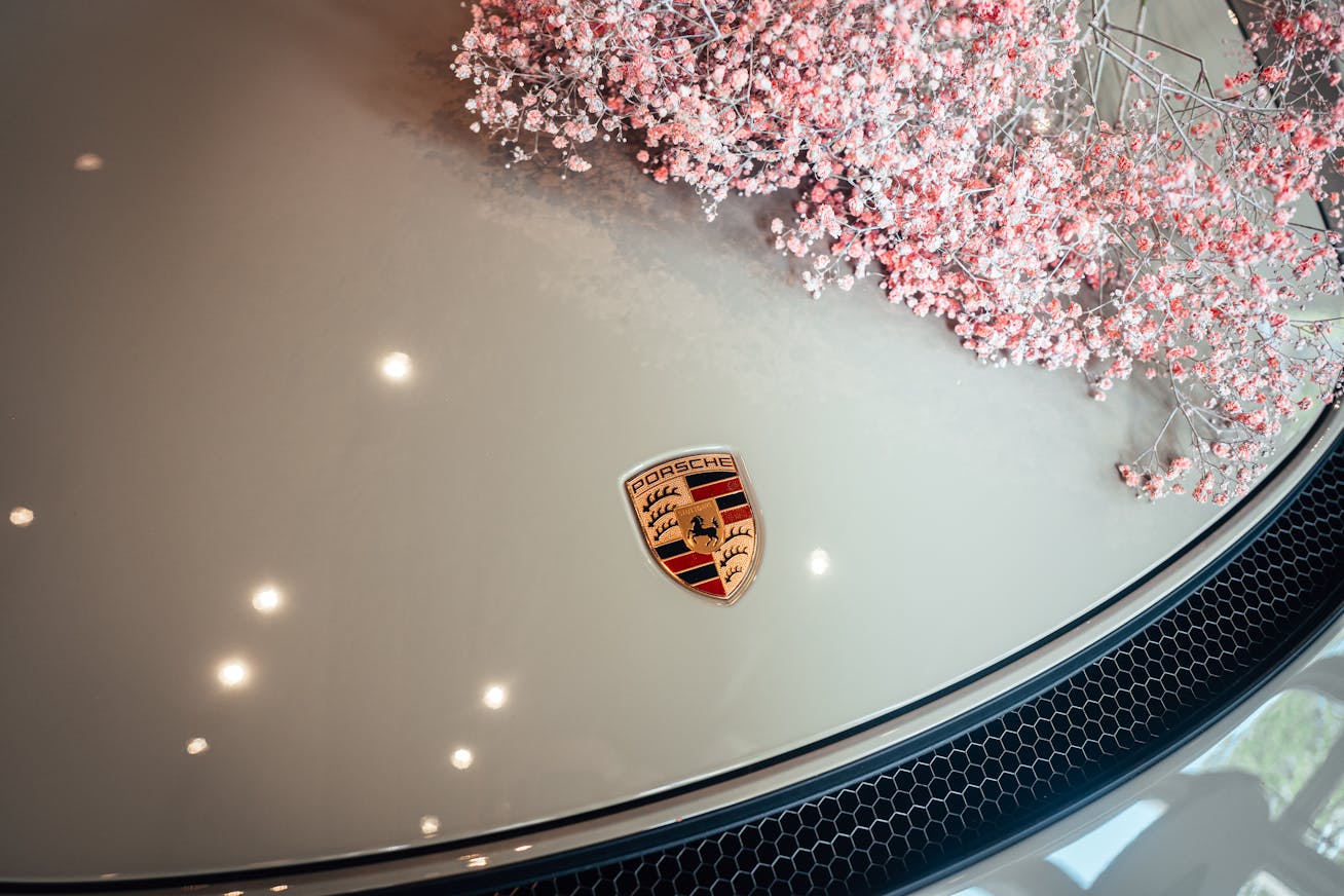 Close-up of Porsche logo on bonnet of classic Porsche 911