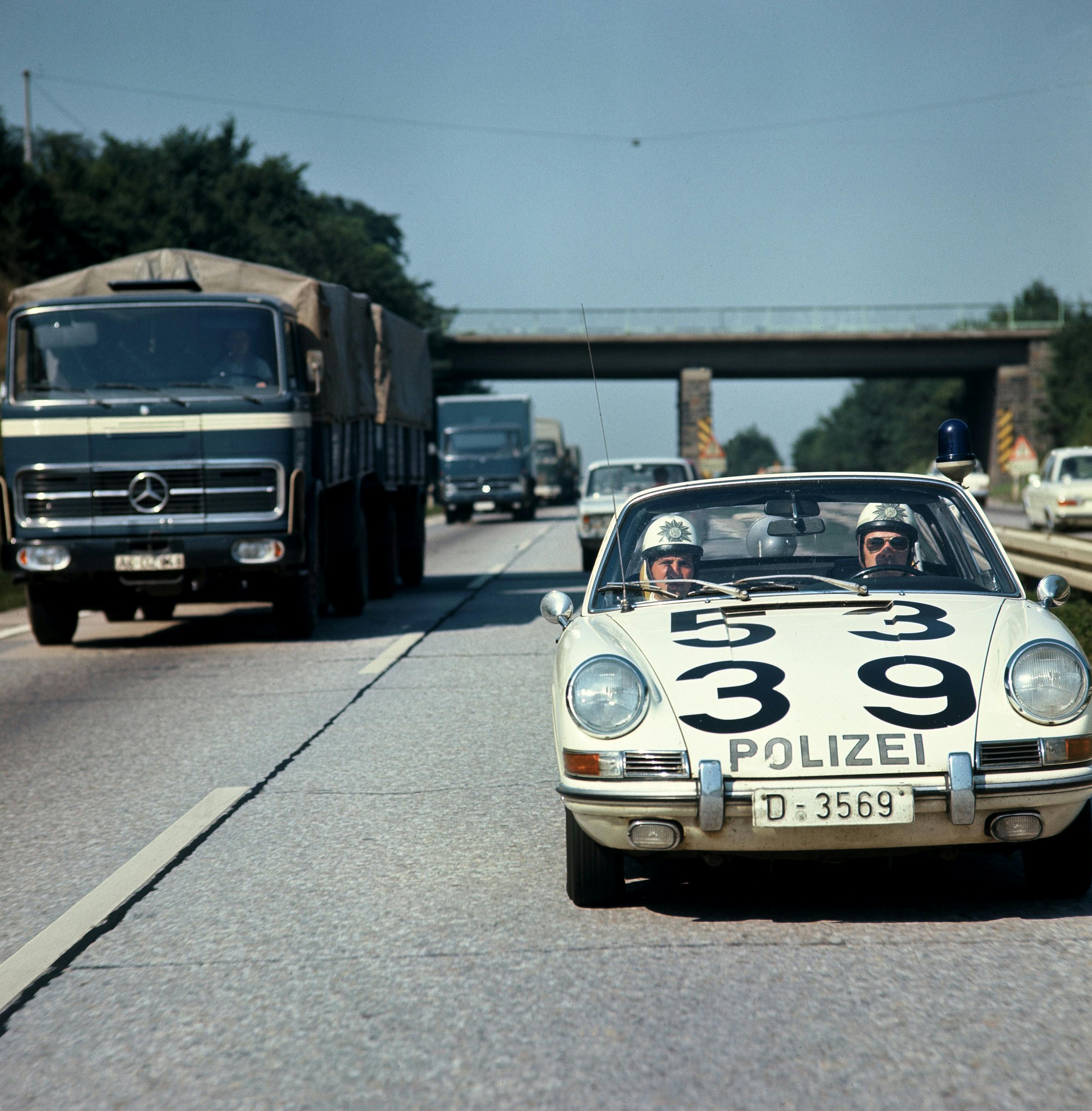 Front view of Porsche 911 police car driving on German Autobahn