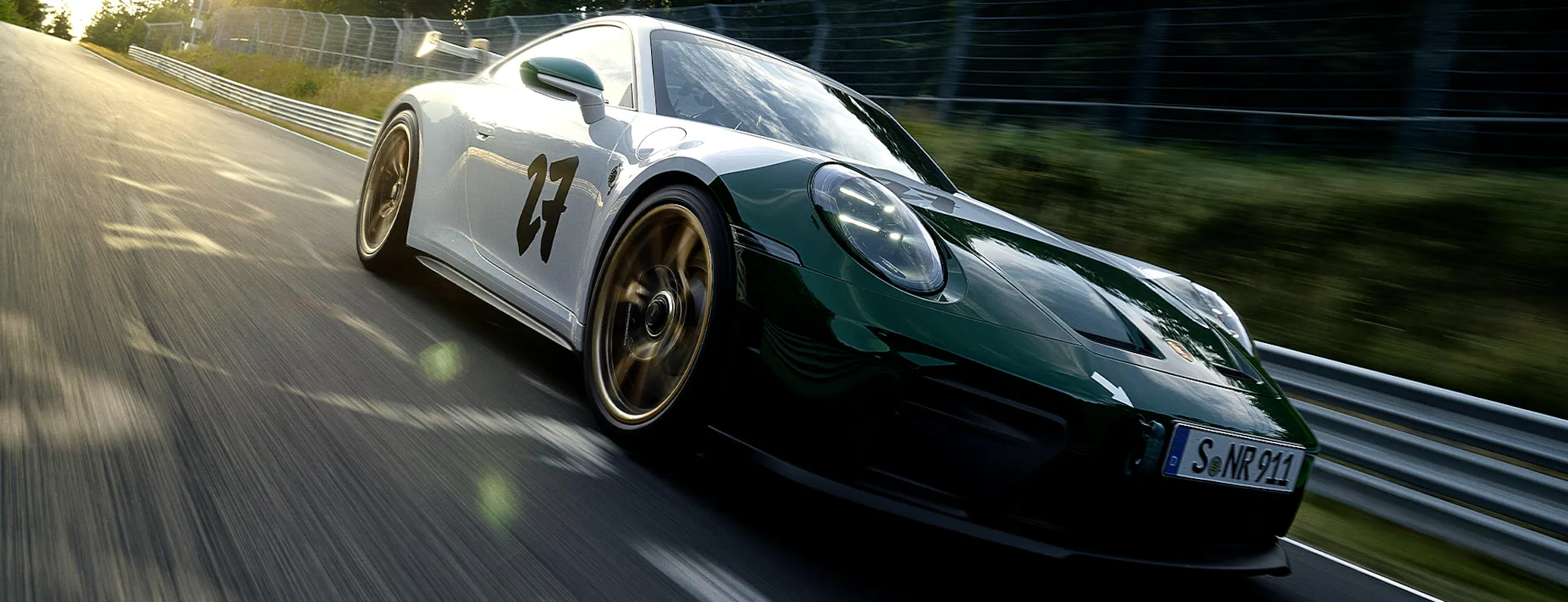 Front three-quarter view of Porsche 911 GT3 100 Jahre Nürburgring driving on Nordschleife hero desktop