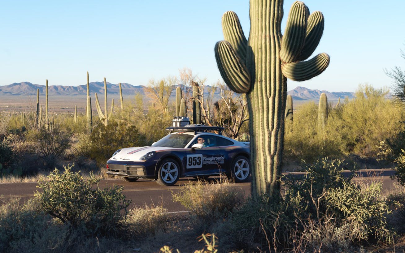 Porsche 911 on desert road, cactus landscape