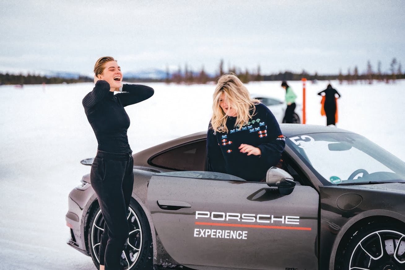 Two women with Porsche 911 at the Porsche Ice Experience in Levi, Finland