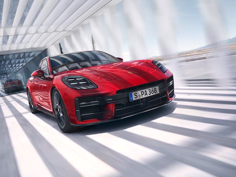 Close-up of red 2024 Porsche Panamera GTS driving