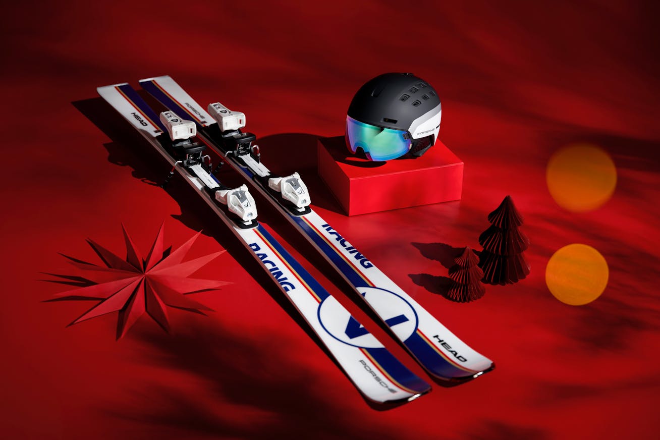 Porsche x HEAD skis and helmet on red background