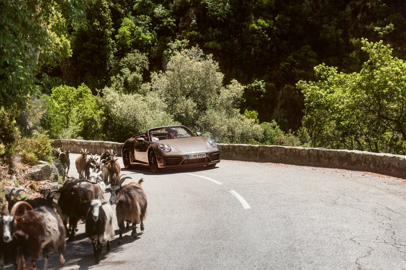 Porsche 911 Cabriolet on a hillside pass in Corsica