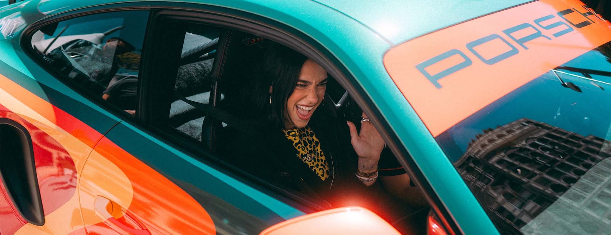 Dua Lipa behind the wheel of a Porsche 911 GT3 RS
