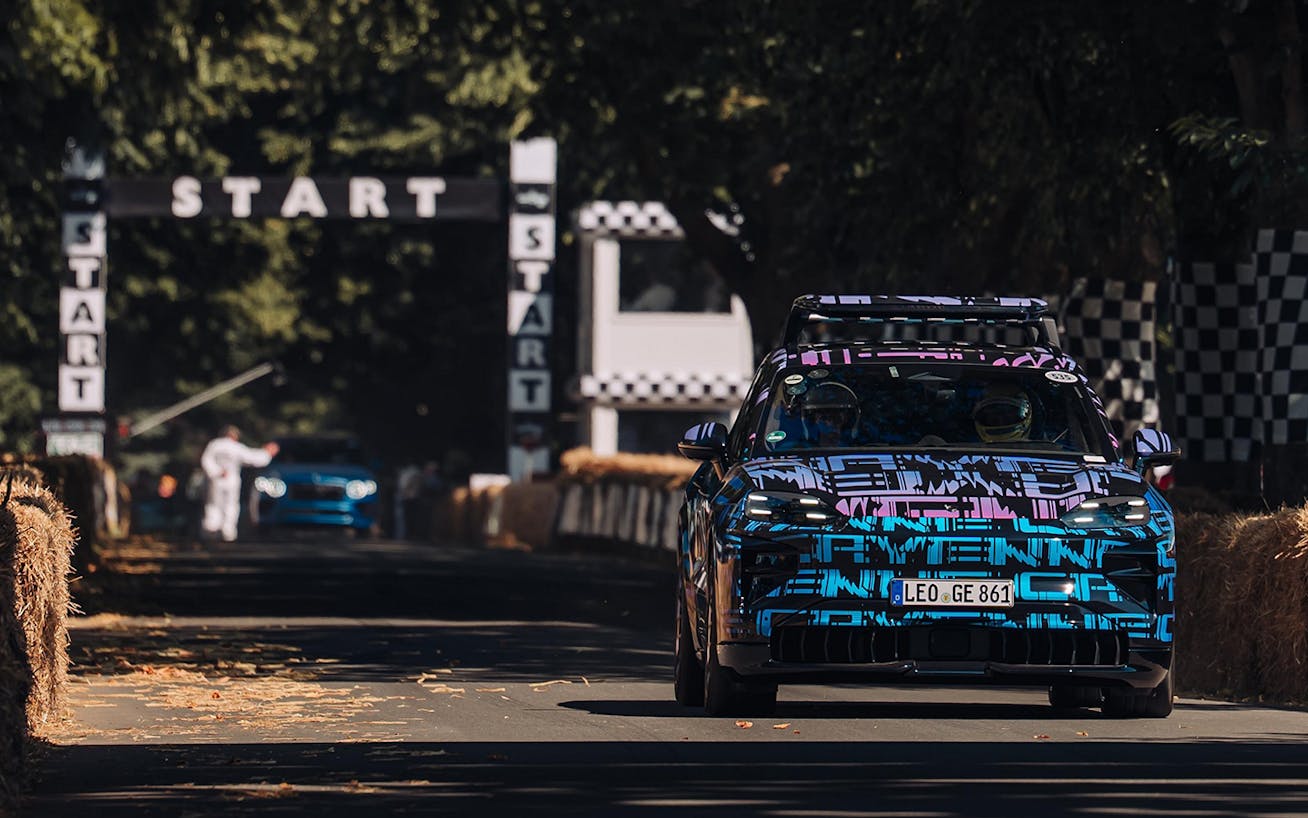 Camouflaged Porsche Cayenne Electric on racetrack 