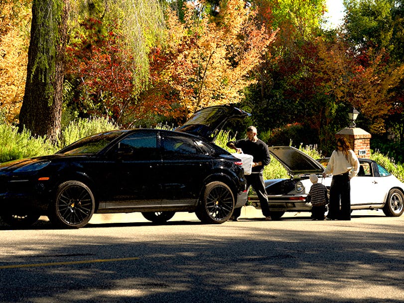 Julie Sarañina and husband Kevin Berruer with Porsche Cayenne E3 and classic 911 Targa