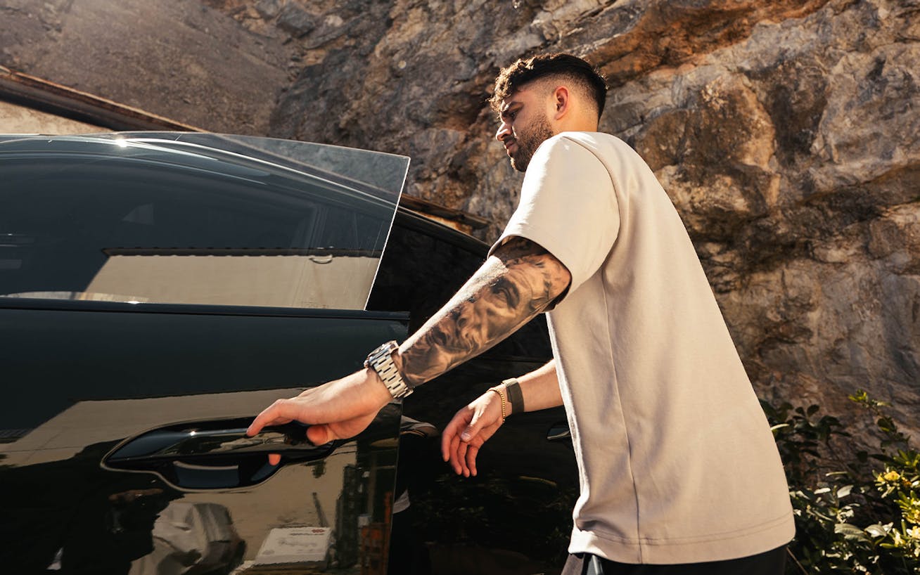 YouTuber Andres Vidoza opens door of Porsche Macan 4S Electric