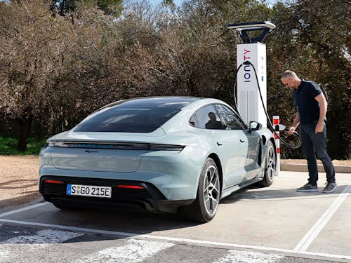 Man charges Porsche Taycan at charging station