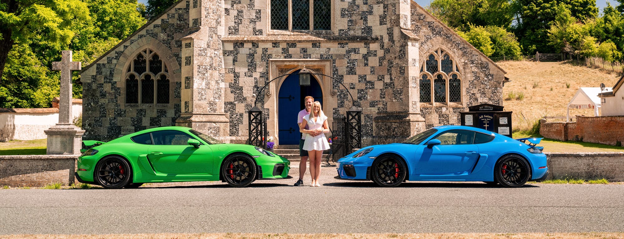 Green and blue 718 Cayman GT4, couple standing in between
