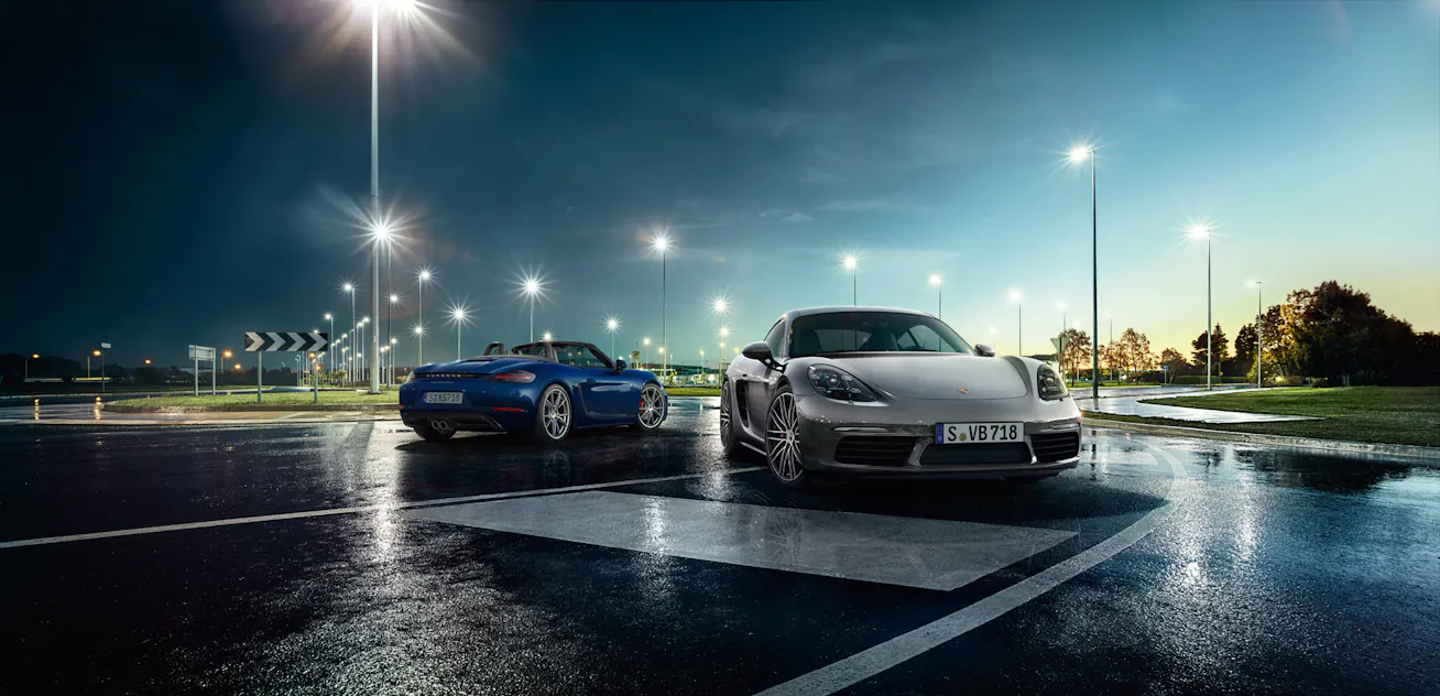 Image showing Porsche 718 Cayman and Boxster in car park at night with lights