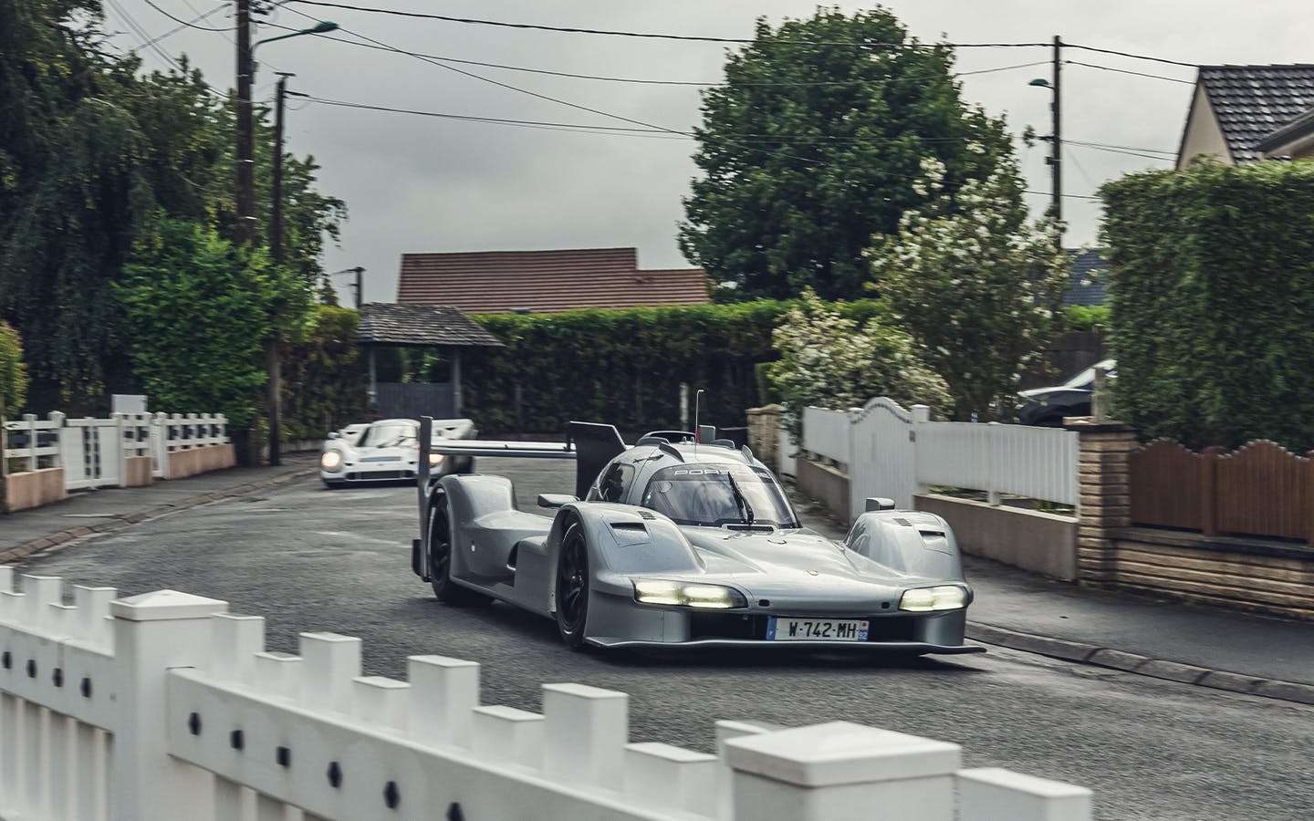 Porsche 963 RSP driving on the streets near Le Mans