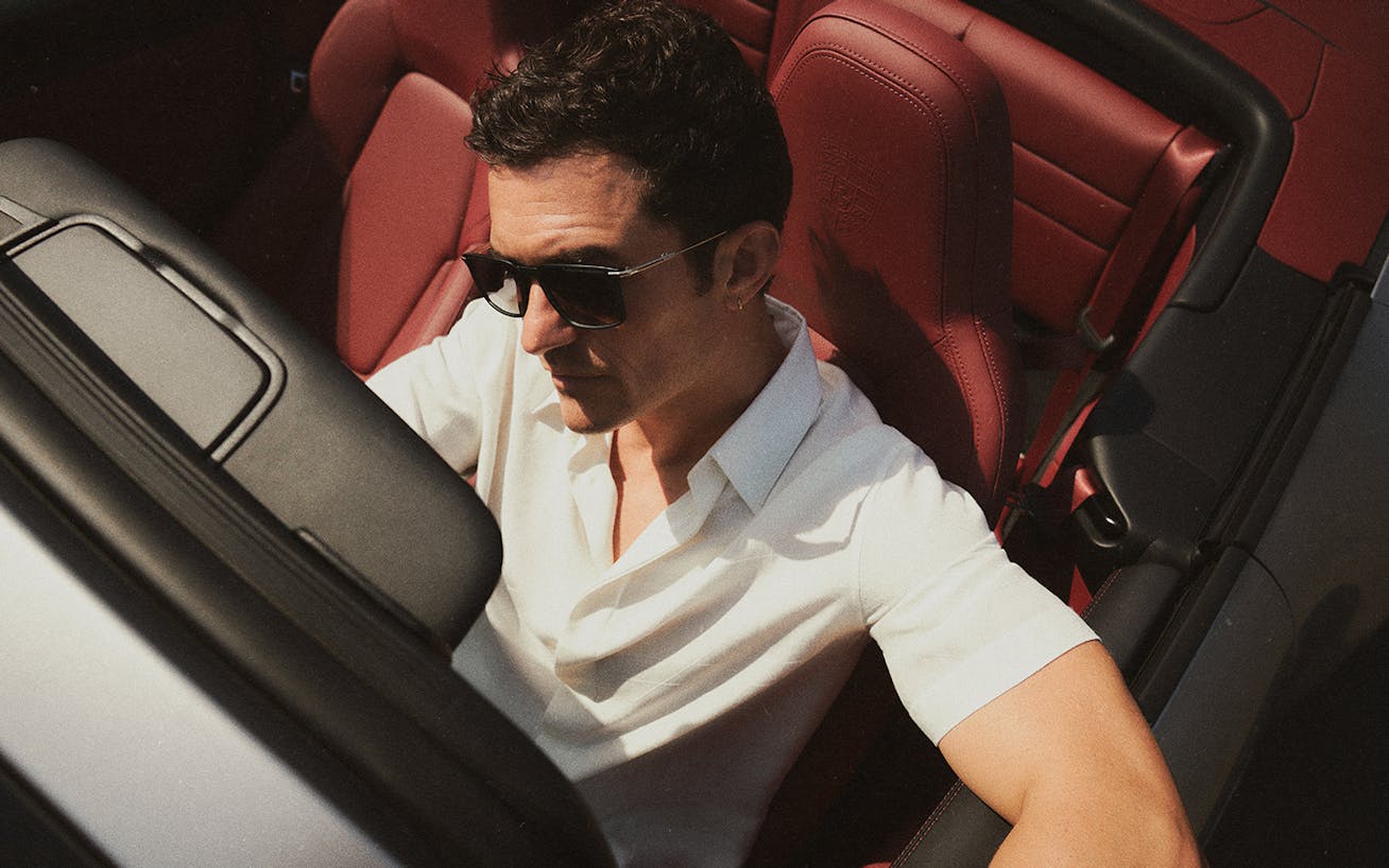 Orlando Bloom sitting in Porsche 911 Carrera GTS Cabriolet