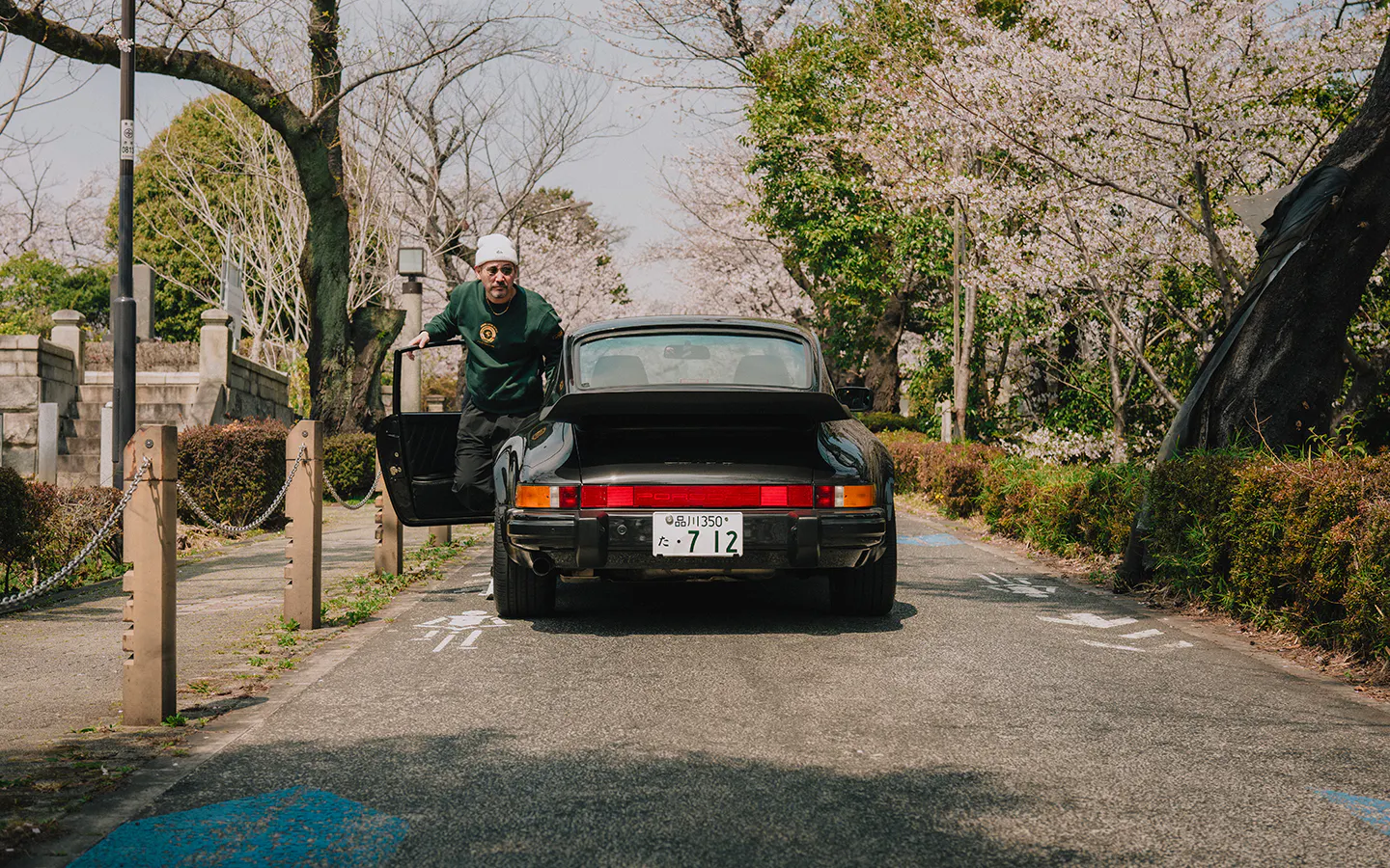 Man stepping out of black Porsche 911 Carrera S/C 