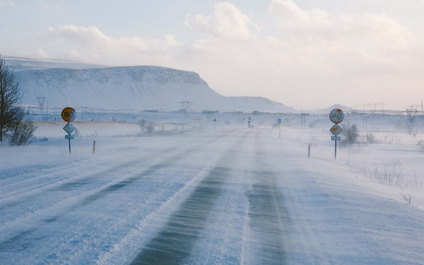 View from inside Porsche Macan Electric driving on a snow-covered road in Iceland