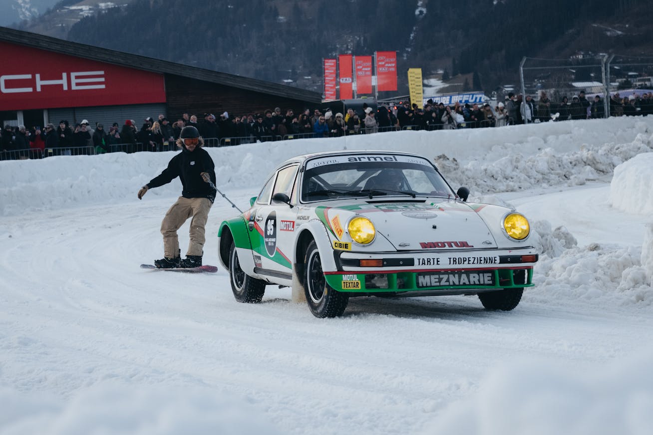 Man skis behind Porsche 911