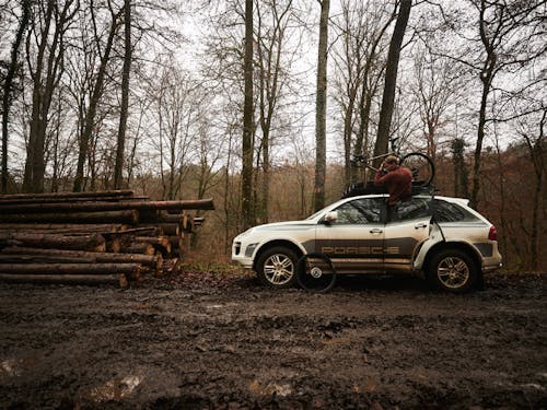 First-generation Cayenne with bike rack next to stack of logs