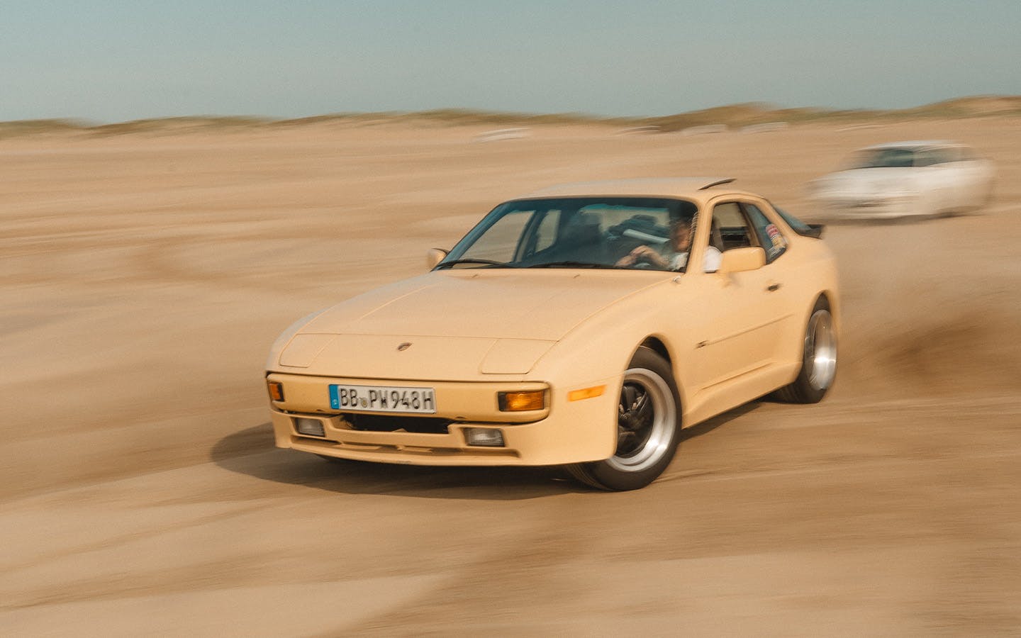 Porsche 944 in Pasadena Yellow drifting across Danish beach