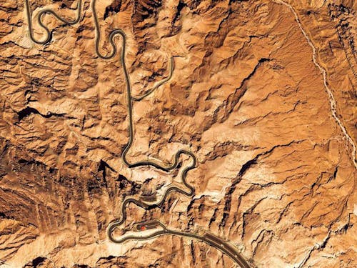 Aerial view of snaking road across mountainous desert