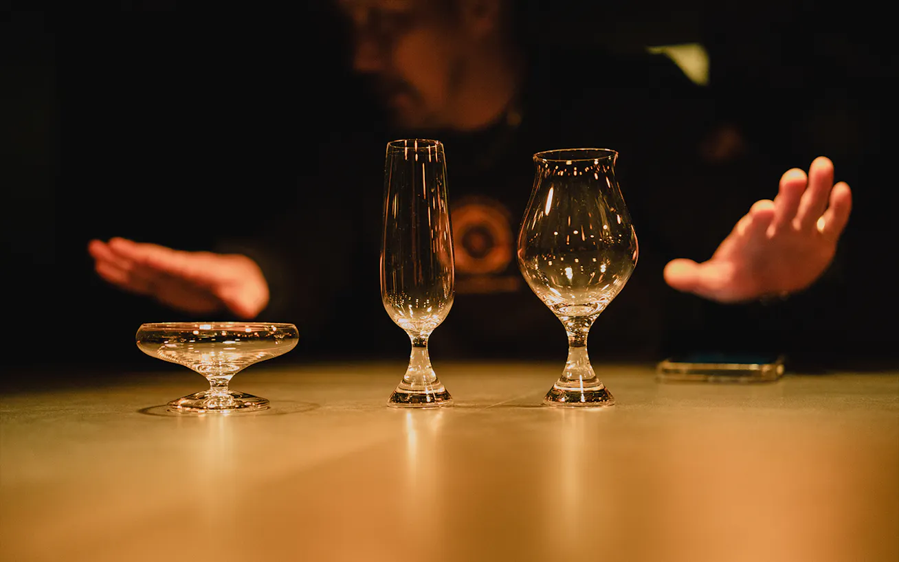 Three handmade sake glasses lined up side-by-side on a table