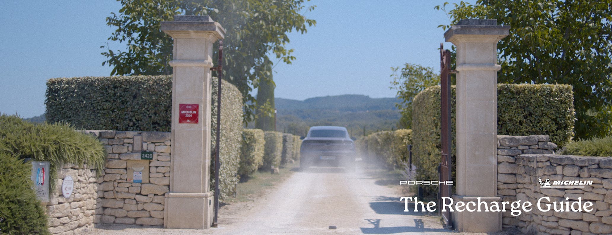 Porsche Macan Electric driving up driveway to hotel in Provence