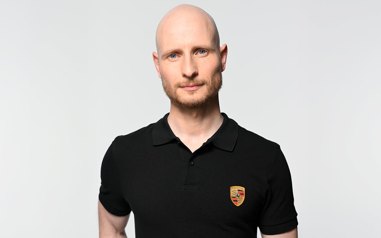 Man in black Porsche polo shirt