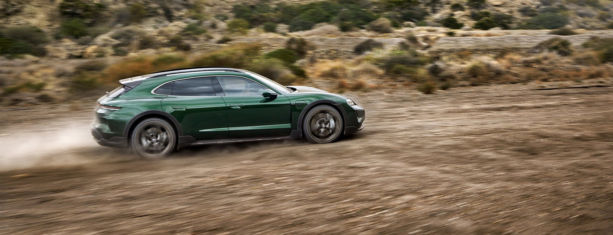 Porsche Taycan Turbo Cross Turismo driving on dirt road