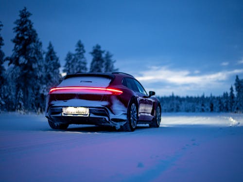 Porsche Taycan Cross Turismo, lights on, at night on snow