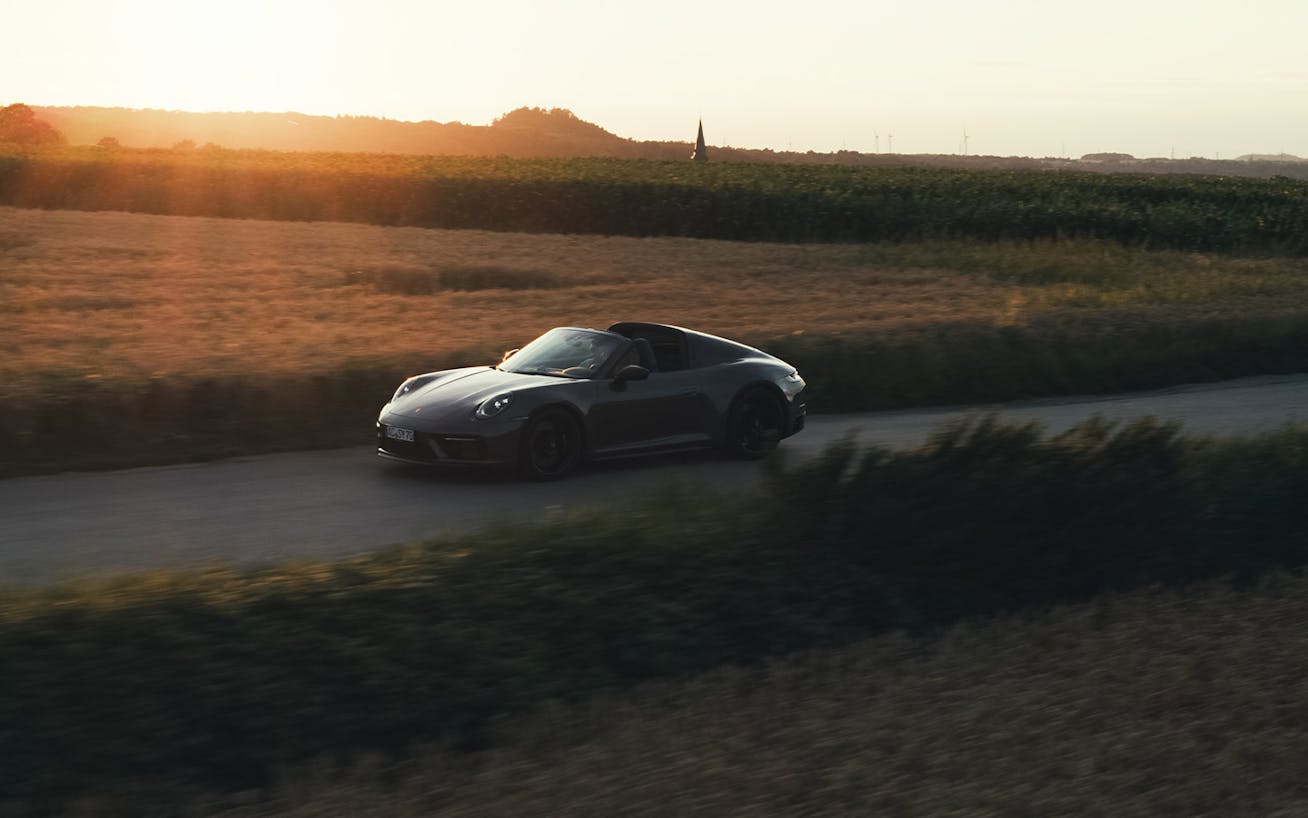 Silhouette of 911 Targa 4S at dusk, driving on road