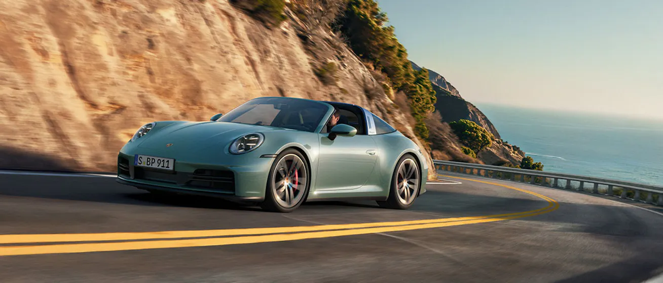 Porsche 911 Targa 4S (type 992.2) cornering on ocean road