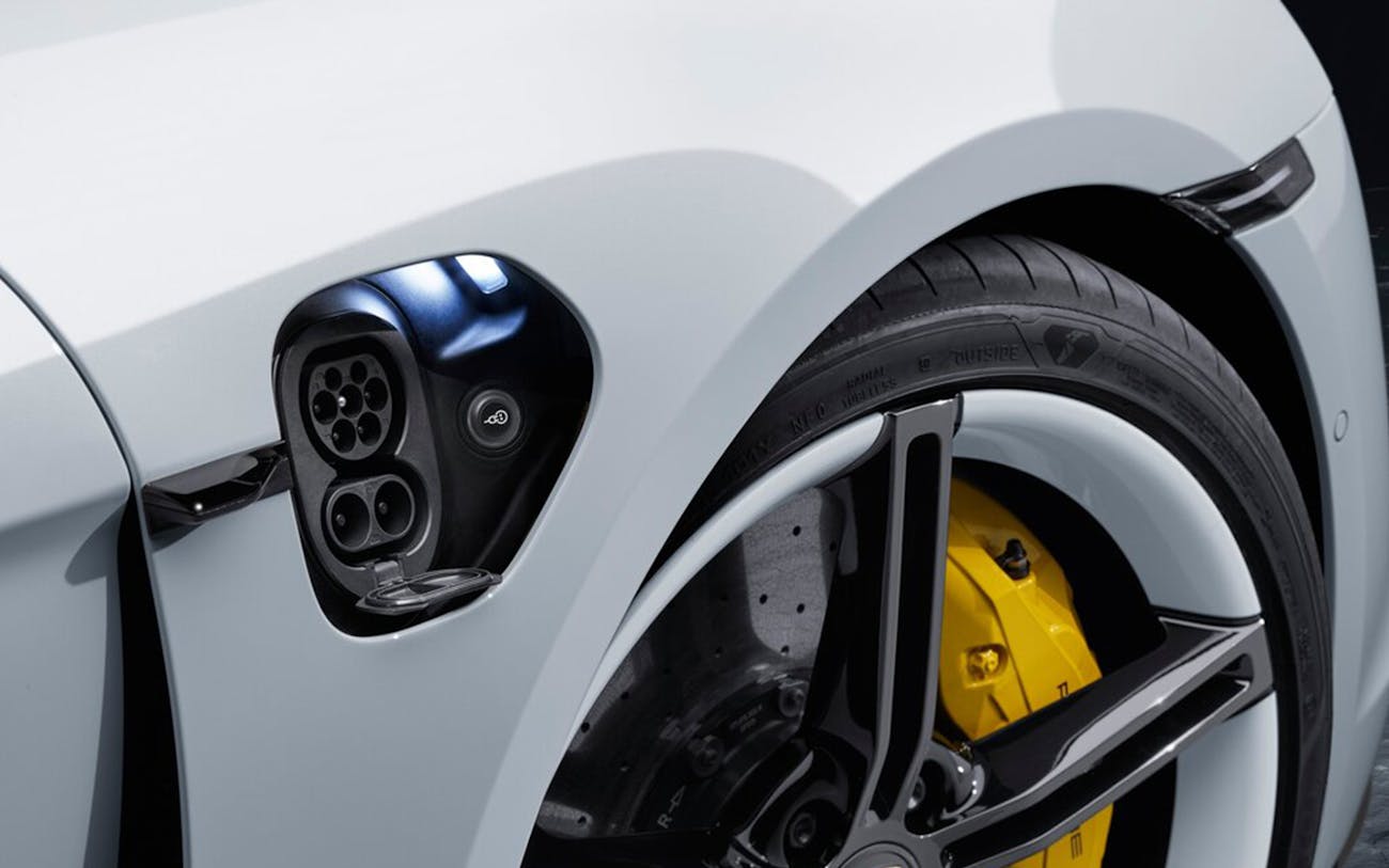 Close-up of Porsche Taycan with charging port flap open