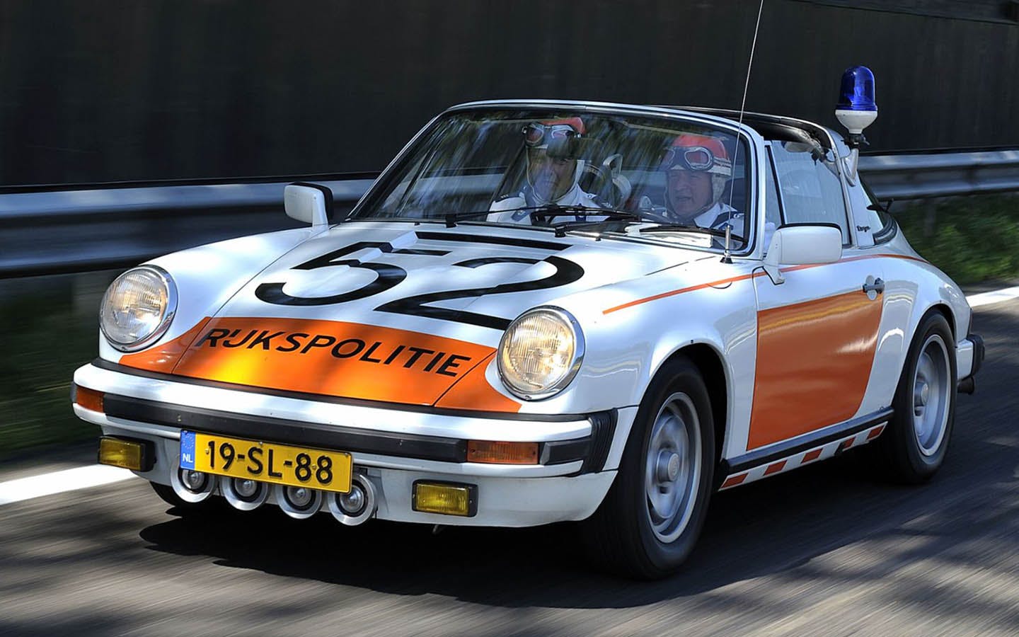 Porsche 911 police car driving on road  by Dutch police 