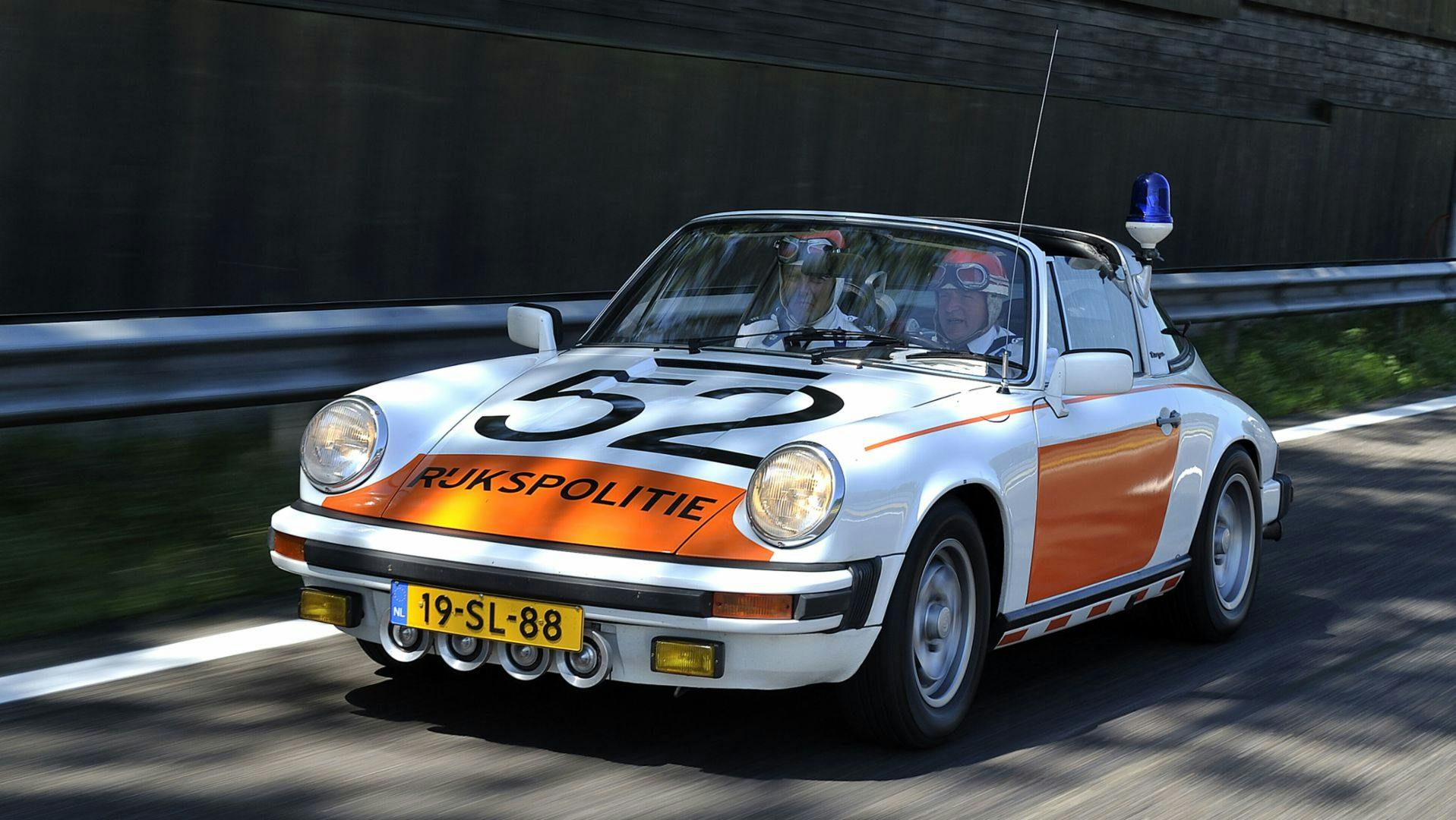 Porsche 911 police car driving on road  by Dutch police 
