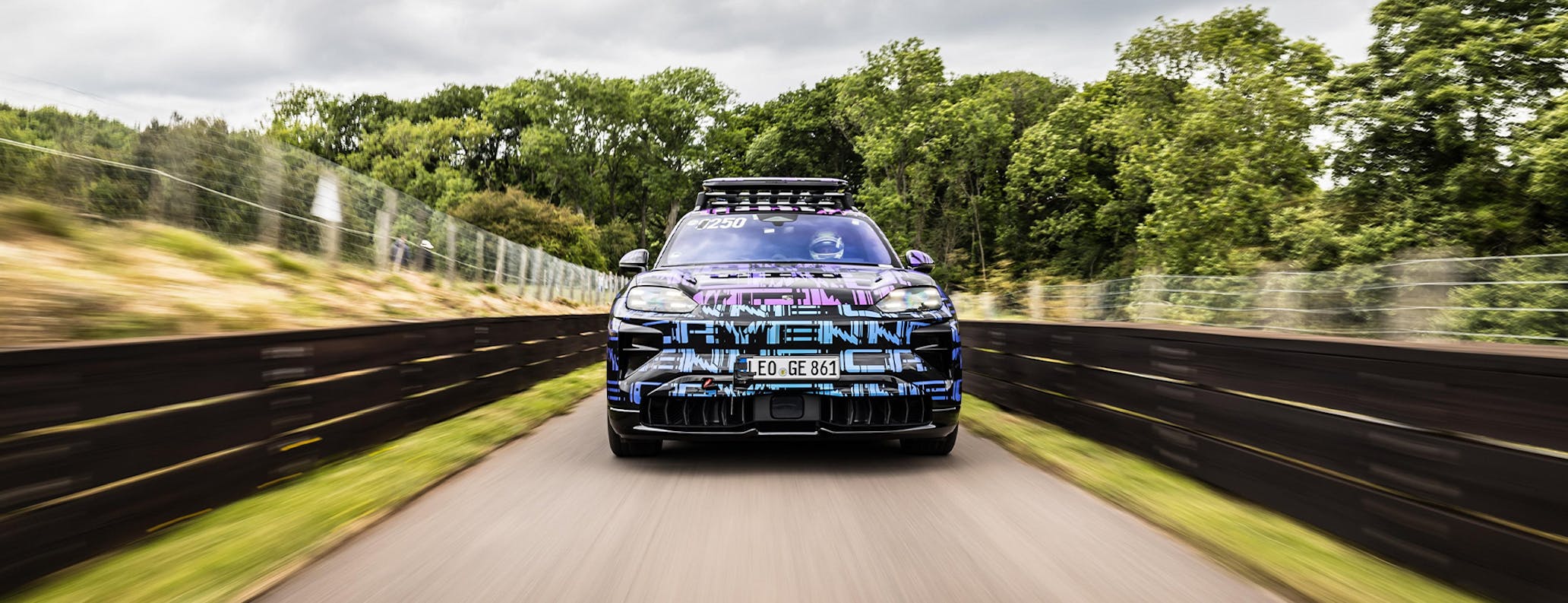 Camouflaged near-production Porsche Cayenne Electric driving on track 