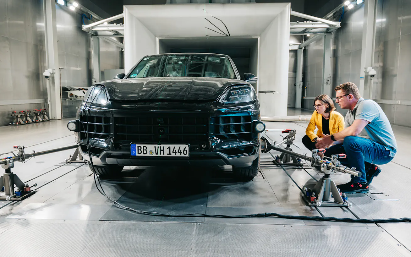 Porsche Patricia Bernstein in testing facility with Cayenne and colleague Shaping Porsche series